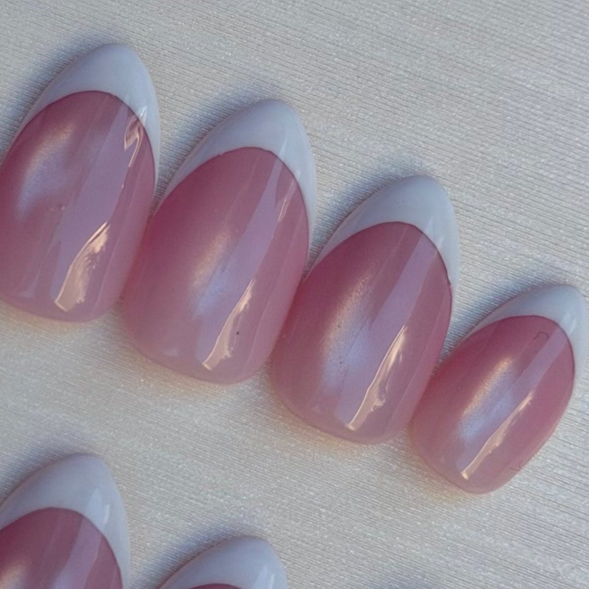 Pink Cat-Eye French press-on nails, close-up of the hand-painted detail