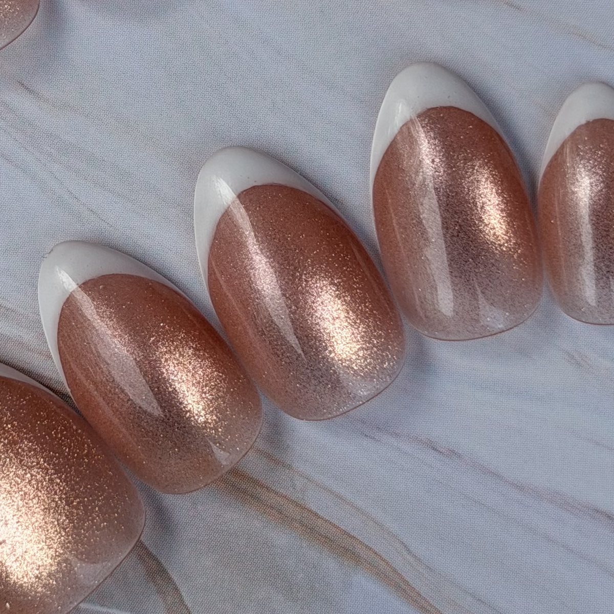 Rose-Gold French press-on nails, close-up of the hand-painted detail